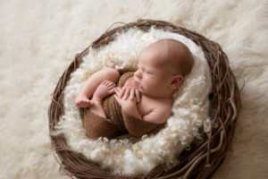 newborn baby boy in basket
