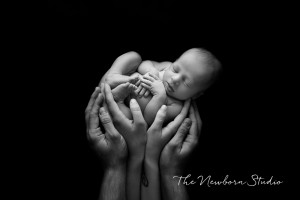 black white newborn baby parents hands