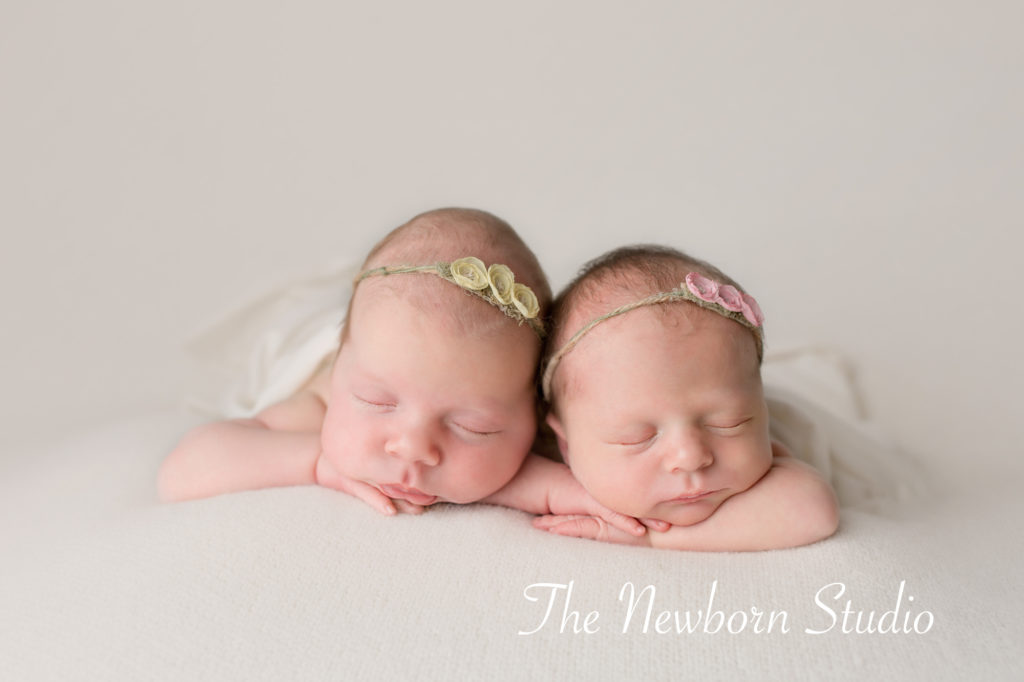twin baby girls on beanbag studio light newborn twins
