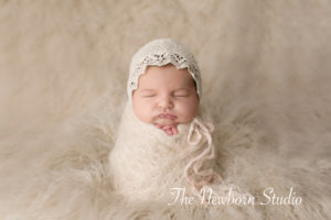 baby girl wrapped newborn studio