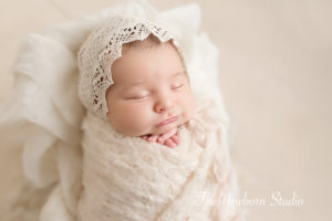 newborn baby girl wrapped smiling