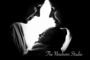 newborn baby girl parents backlit black and white