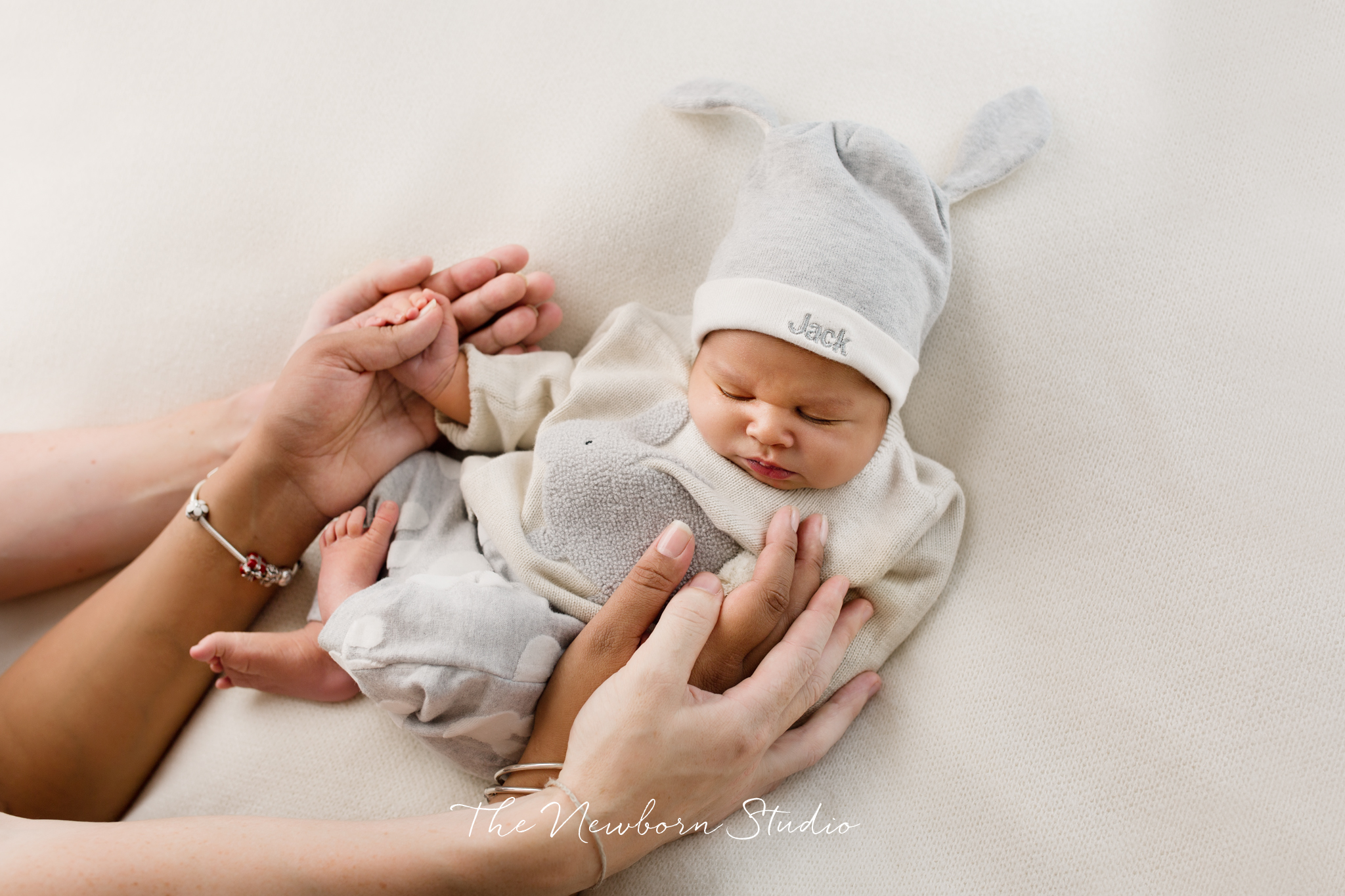 baby boy dressed in parents hands