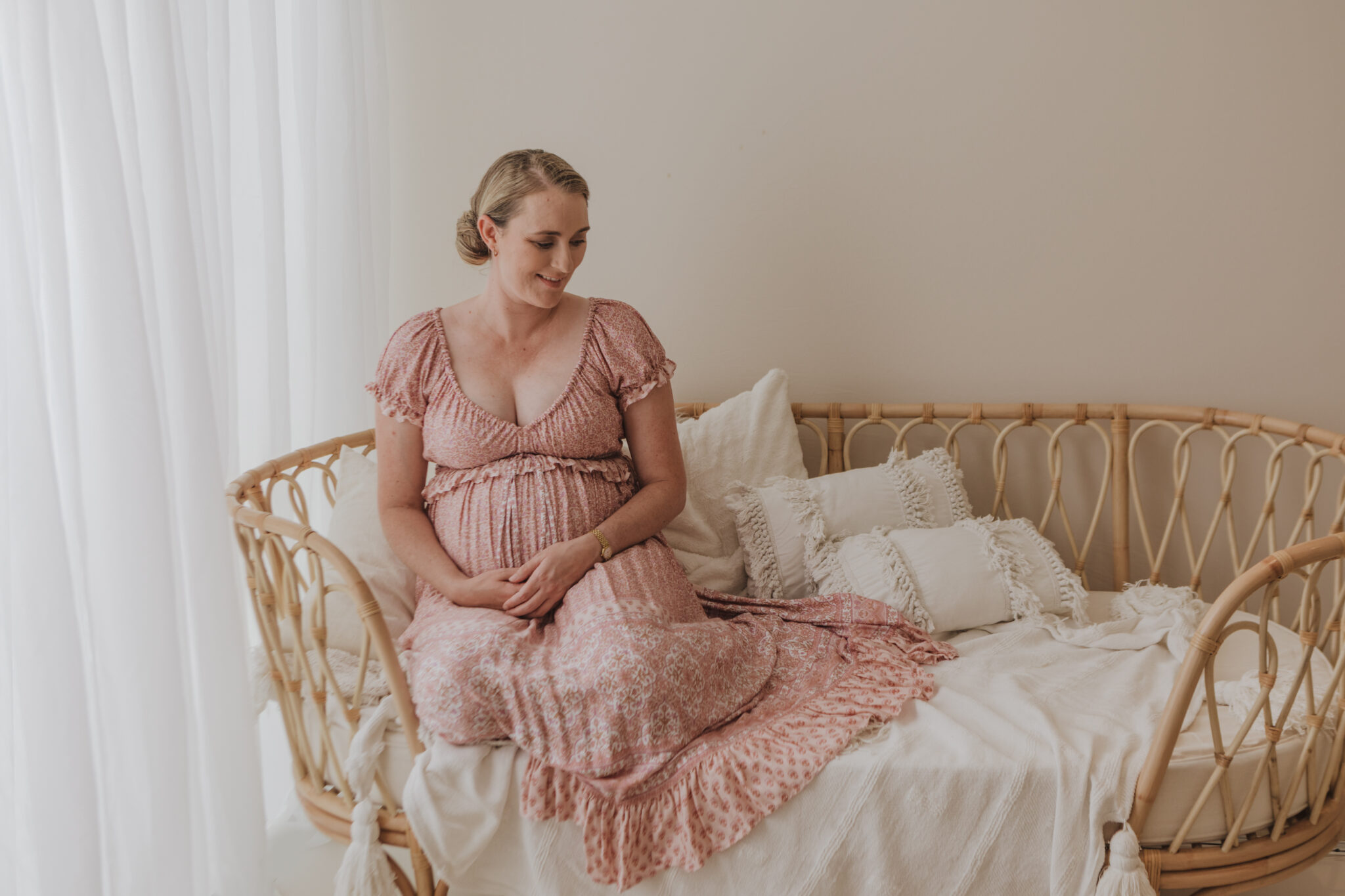 pregnant woman on couch in photo studio