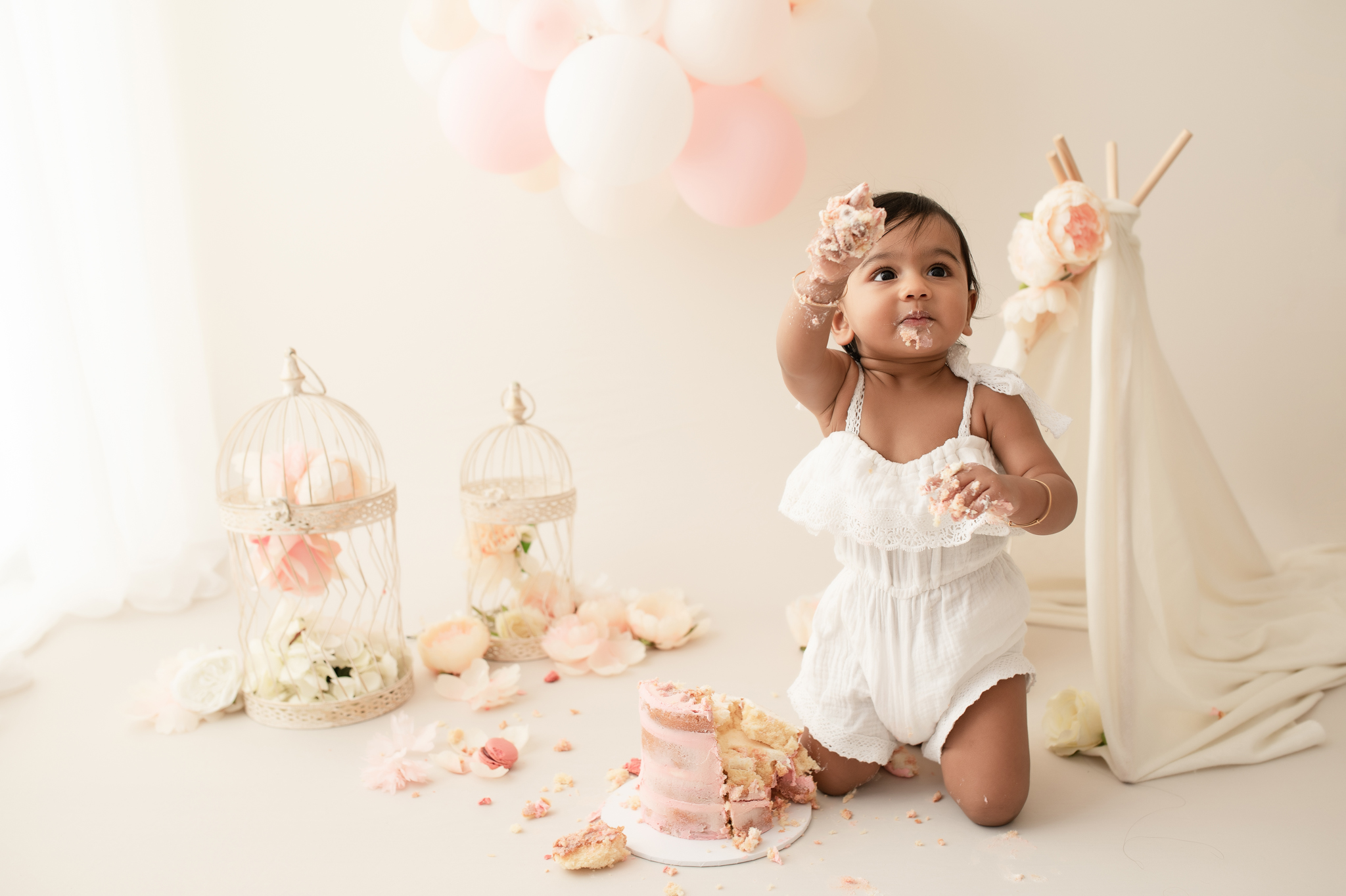 baby girl in studio doing a cake smash session