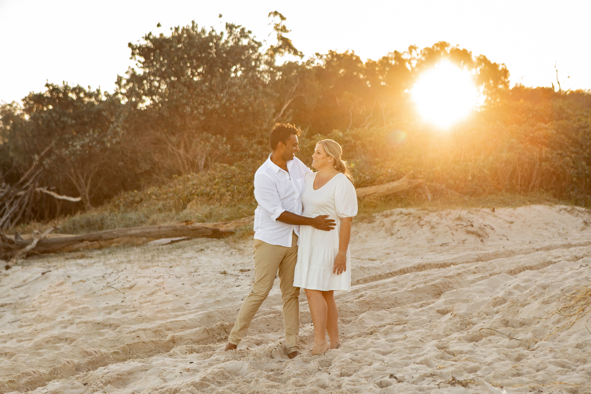 married couple on the beach at sunset