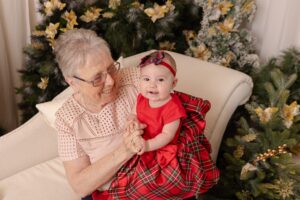 baby sitting on grandparents knee at christmas