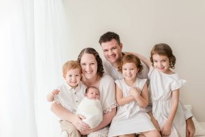 family in the studio with newborn baby