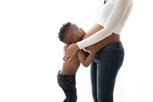 boy hugging pregnant mum